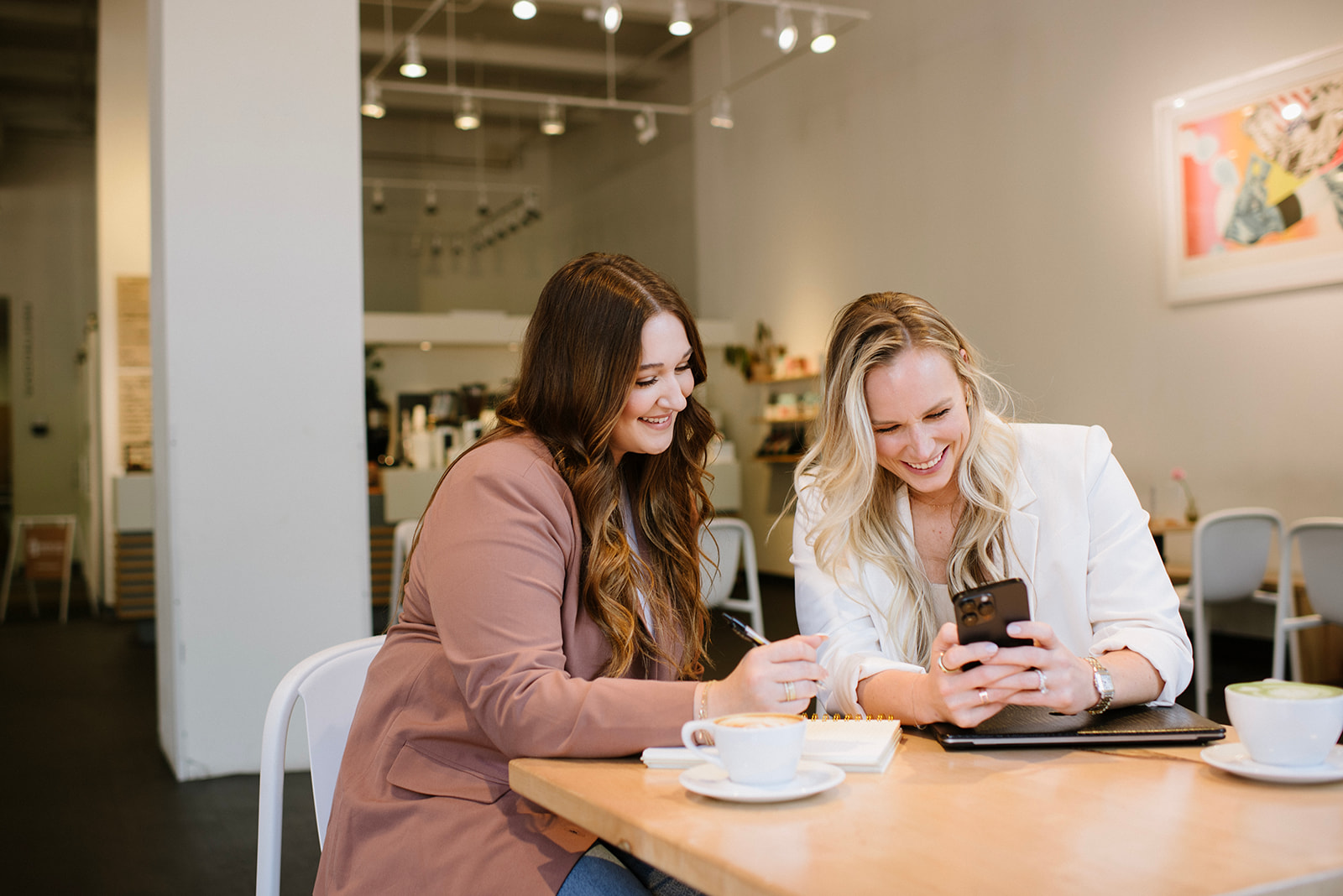 Two Tique team members planning for a brand photoshoot